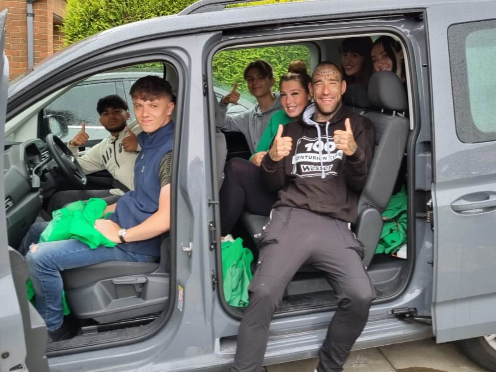 People with charity fundraising jobs, riding in a mini bus.